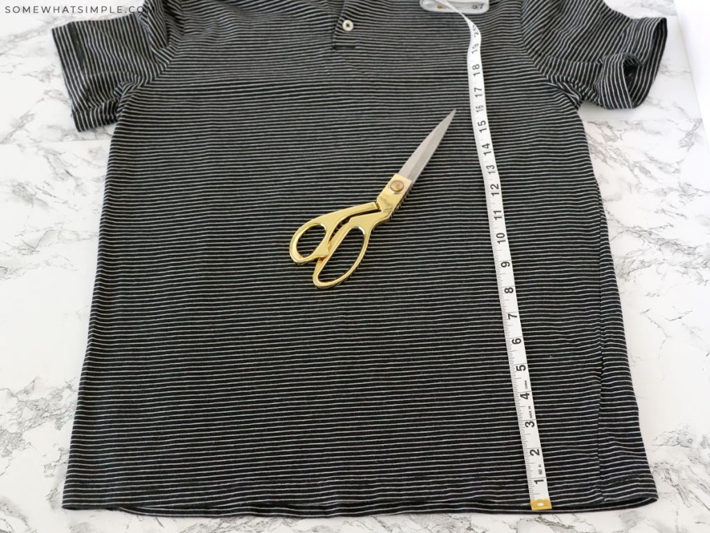 making the first cut on a man's shirt to make a skirt