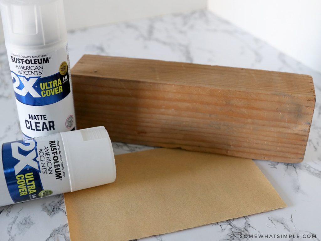 spray painting a block white for Seasonal Home Decor