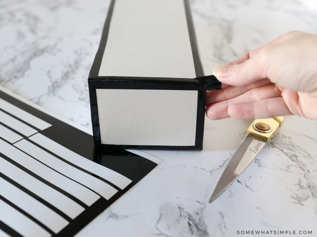 adding vinyl strips to a wood blok