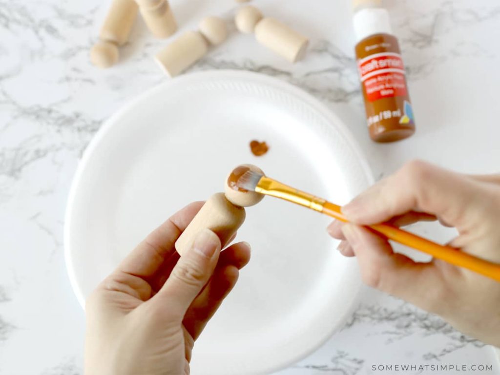 painting the head of a Wooden Spool Doll