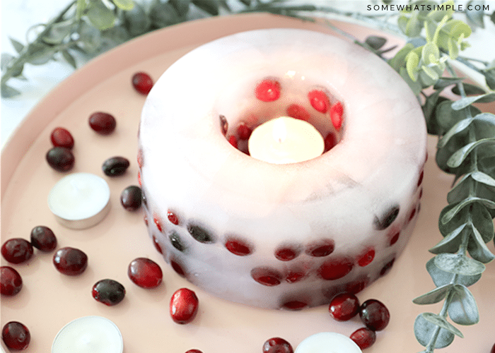 ice candle with cranberries on a platter