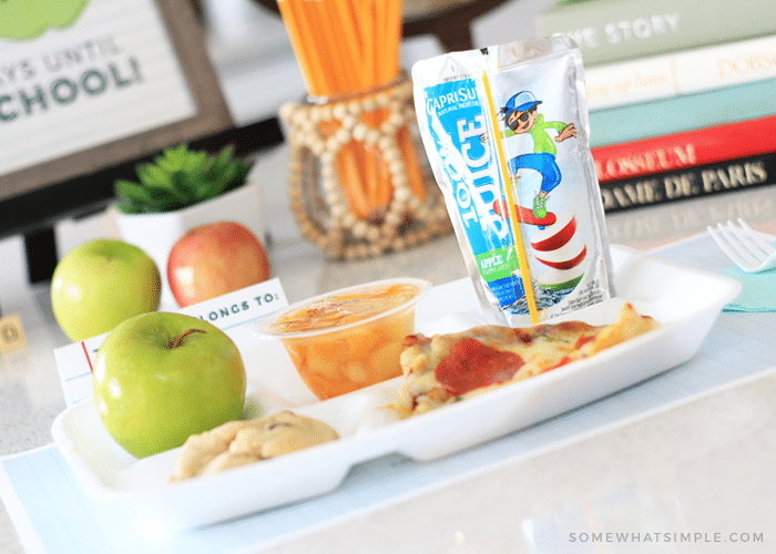 http://somewhatsimplekids.com/wp-content/uploads/2020/07/back-to-school-dinner-family-lunch-tray-creative-ideas-place-settings-apple-fruit-cup-capri-sun-pizza-cookie-fhe-bts-party.png