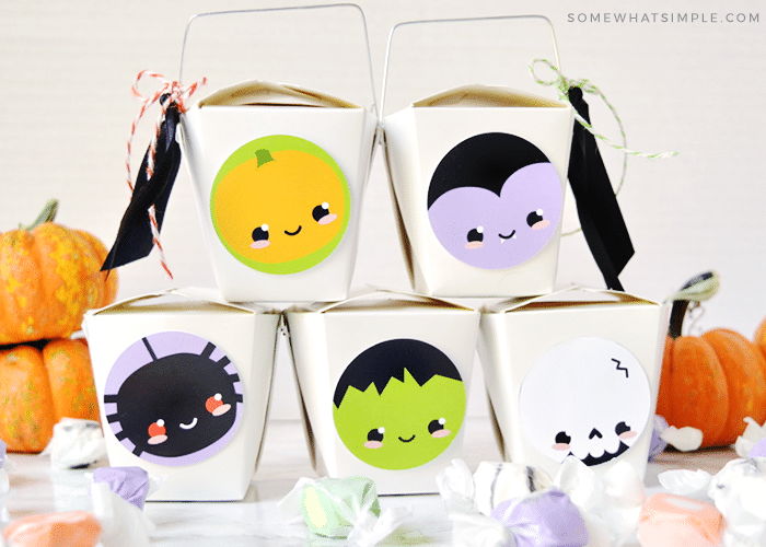 a stack of halloween gifts made with takeout boxes
