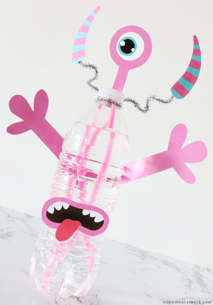 pink monster made from printables, glow sticks and a water bottle