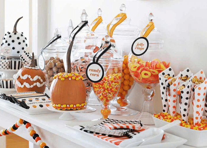 Halloween Candy DIshes on the counter filled with yellow and orange candies