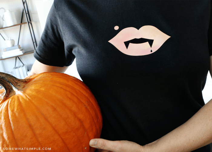 halloween shirt on woman holding pumpkin
