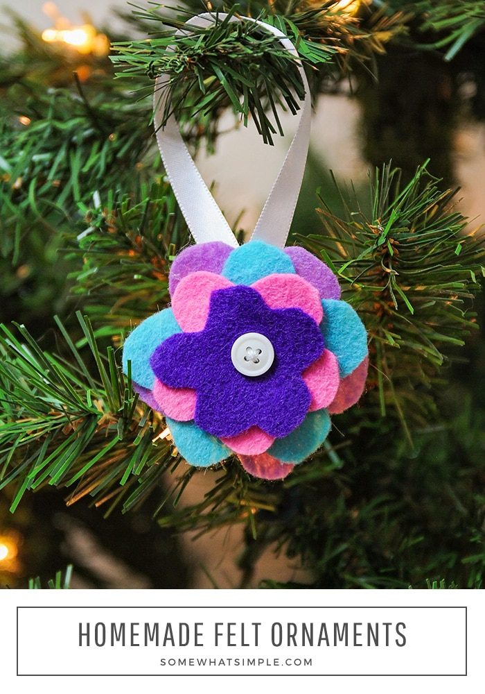 Easy felt ornaments are made with a stack of felt flowers with a button in the center hanging on a christmas tree