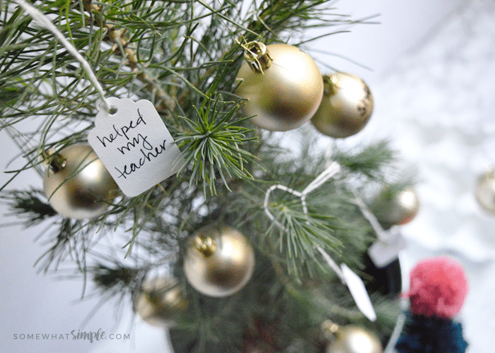 a small christmas tree with acts of service written on tags "The Giving Tree" 