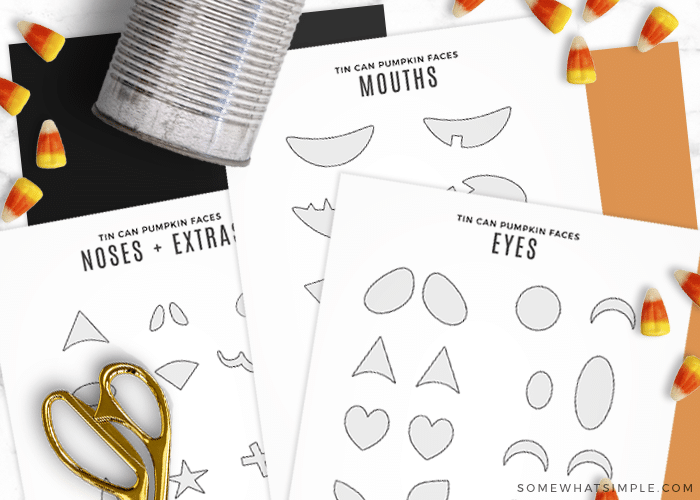 printable pumpkin faces on sheets of paper laying flat with some scissors