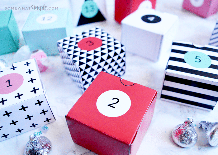 red, white, black and pink paper boxes with numbers on them sitting on a counter 
