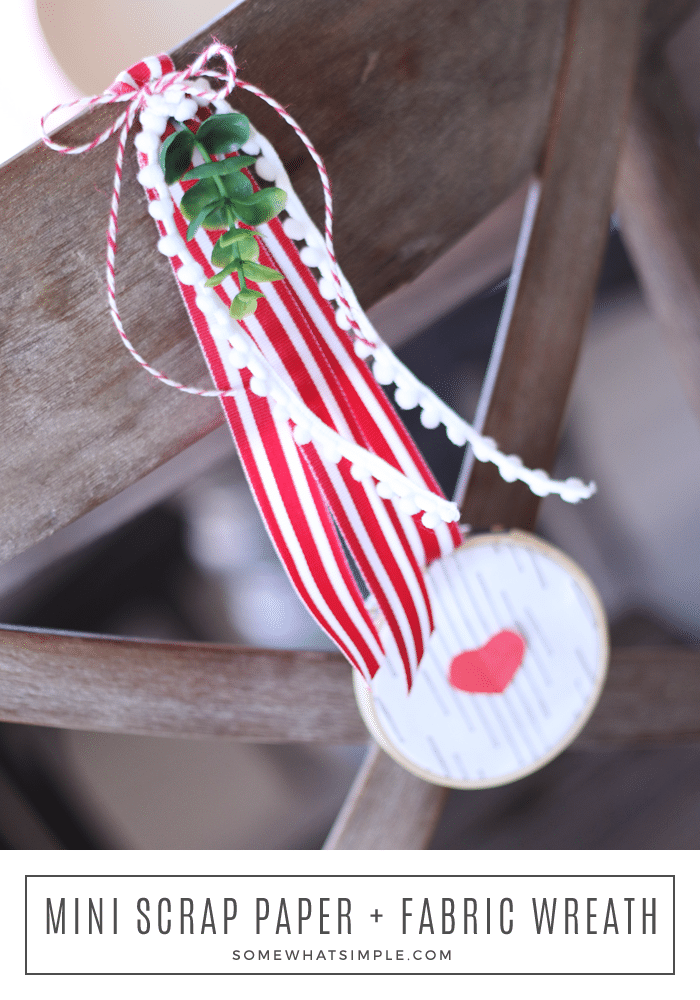 long image of a Mini valentine wreath hanging on a wood dining chair