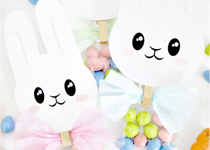 2 paper bunnies attached to treat bags with a wood clip