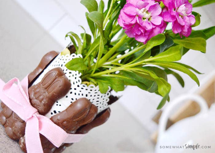 chocolate bunny easter centerpiece with magenta flowers in a white vase