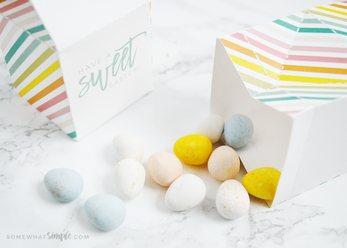 paper milk cartons laying on their side with easter candies inside and on the counter