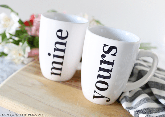 two white mugs with "mine" and "yours" written on them with sharpie markers