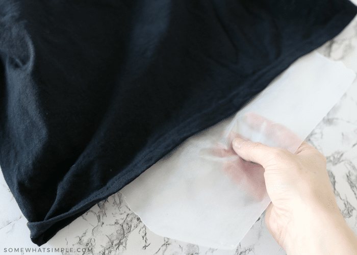 placing a piece of wax paper in between a black shirt