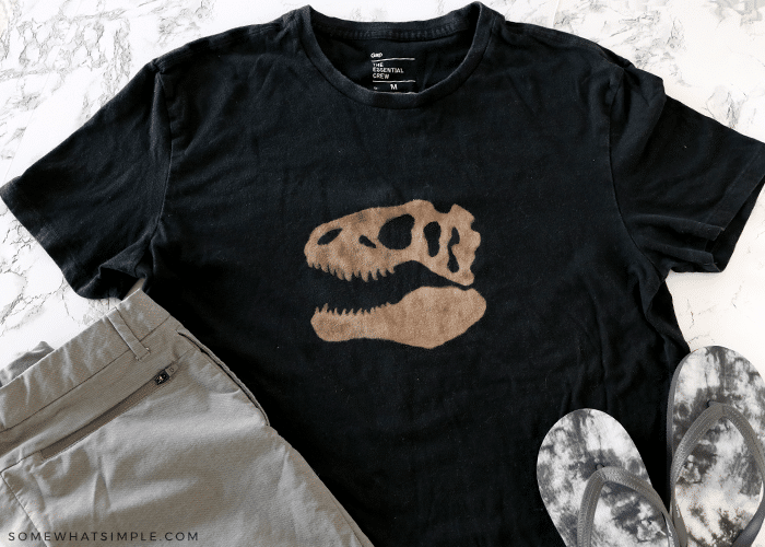 black t shirt with a bleached image of a dinosaur