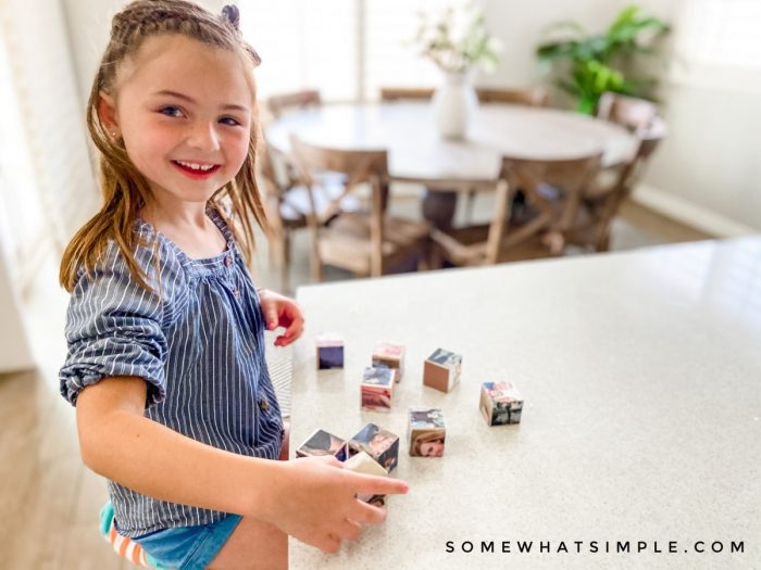 little girl playing with photo block puzzle