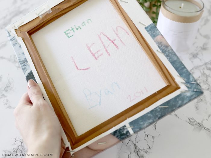 writing names on the back of a canvas