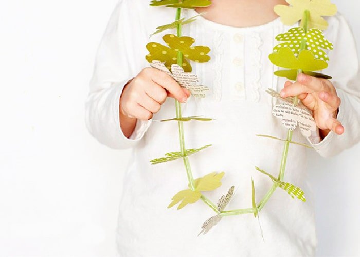 lei made from paper clovers around a child's neck