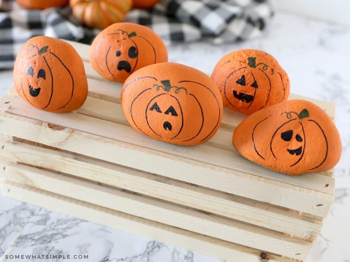 finished rock pumpkins on top of a wood crate