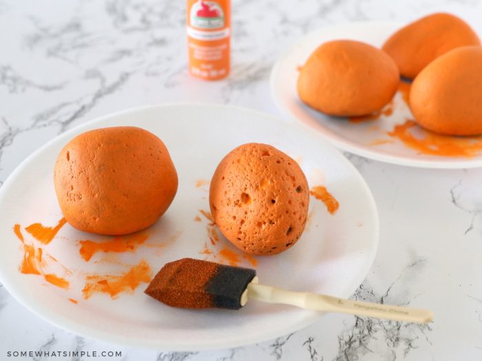 painting river rock with orange paint