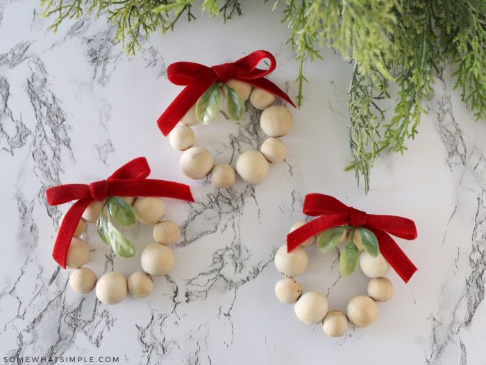 3 wood bead ornaments on a white counter