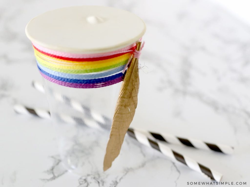 making a homemade drum from a cup and balloon