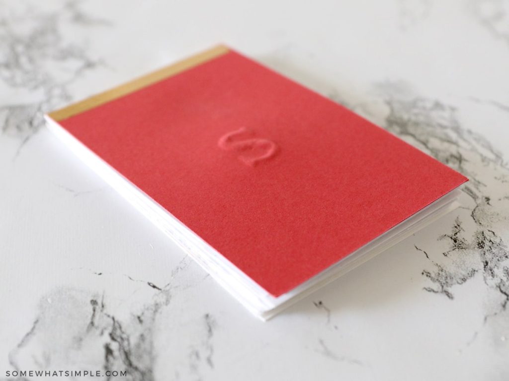 embossed red notepad with a letter S