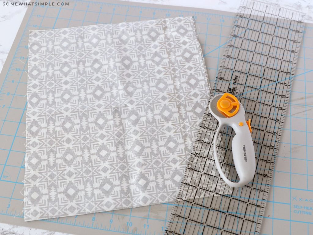 cutting out gray fabric to make a tote bag