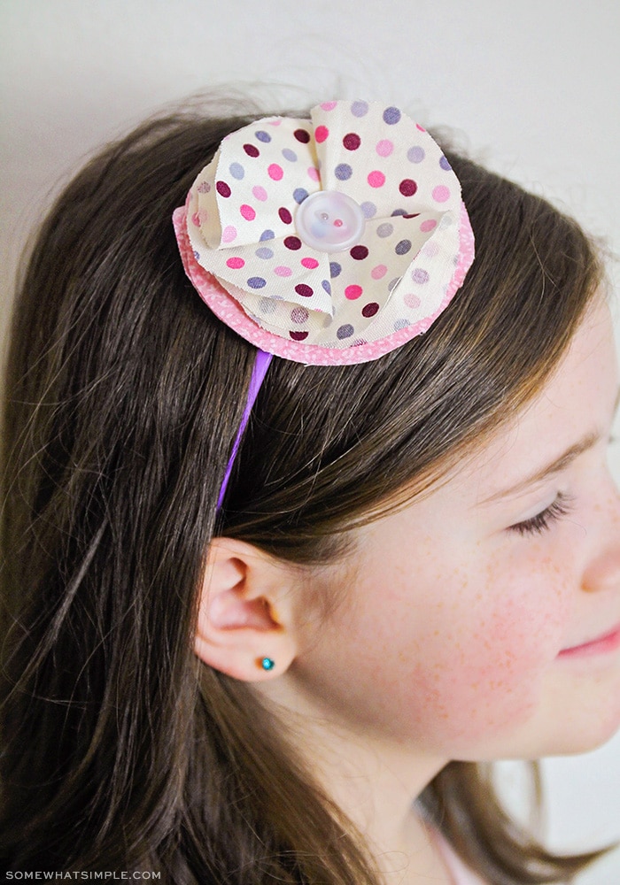 little girl wearing a fabric flower headband