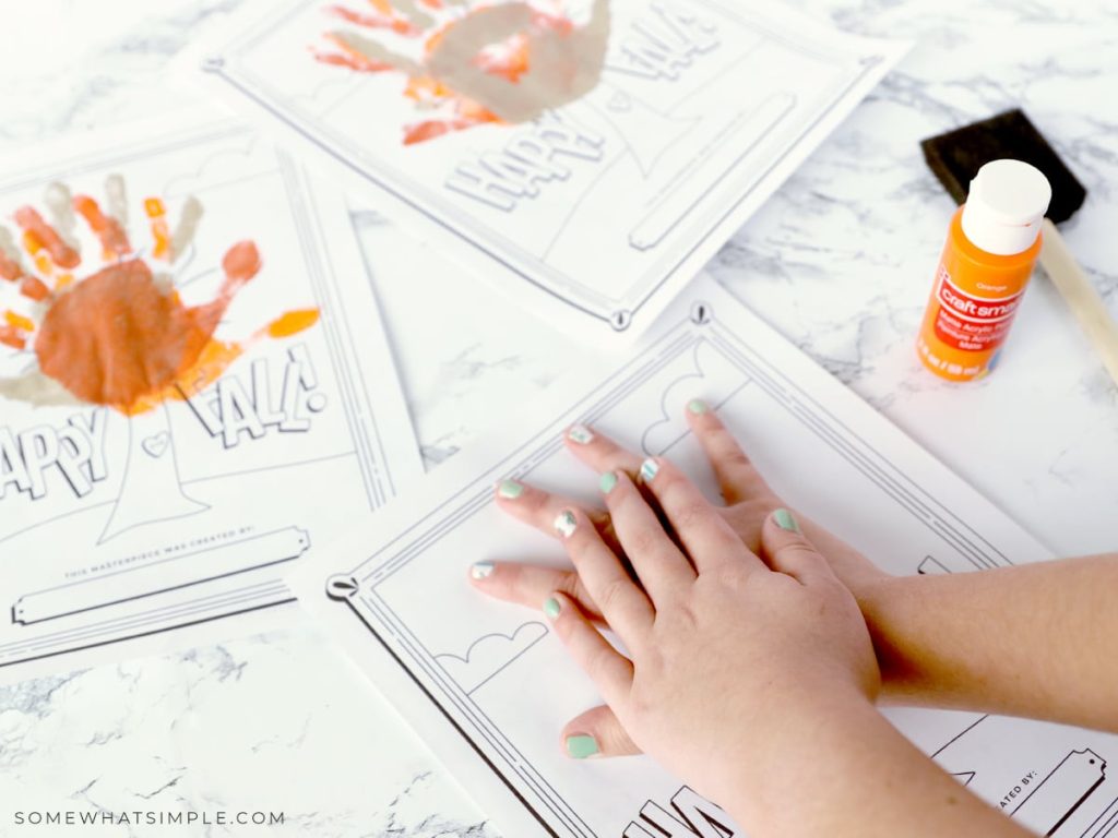 child's hands on a coloring page