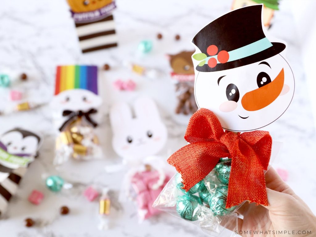 holding a snowman treat bag topper