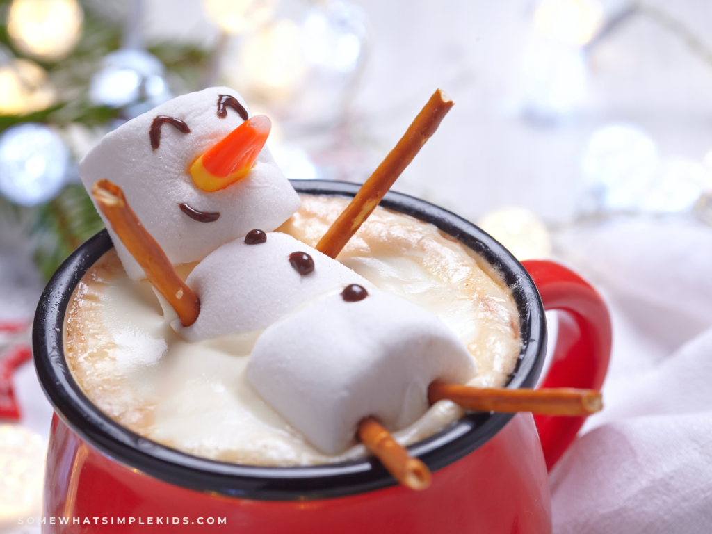 snowmen made from marshmallows in a cup of hot cocoa