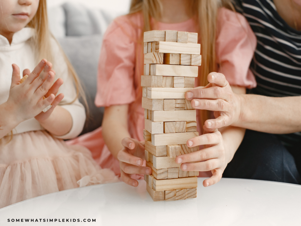 family hands playing Jenga