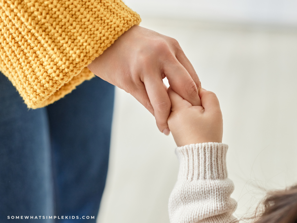 mom holding baby's hand