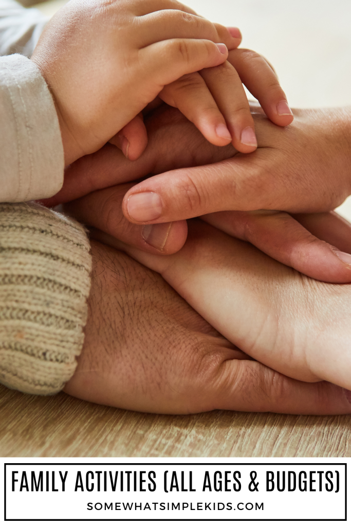 long image of a families hands stacked on top of each other