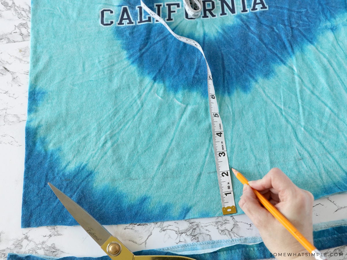 measuring an old t shirt to make a tote