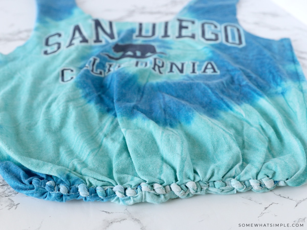 tied fringe on a t shirt to seal it up and make a bag