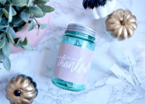 Thanksgiving Countdown Jar on the counter next to decorative pumpkins