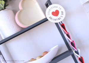 heart shaped paper chain countdown hanging on the side of a bookshelf