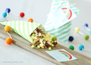 treat bag with candied popcorn and rainbow pom poms for st particks day