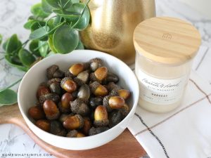 bowl of acorns next to a candle