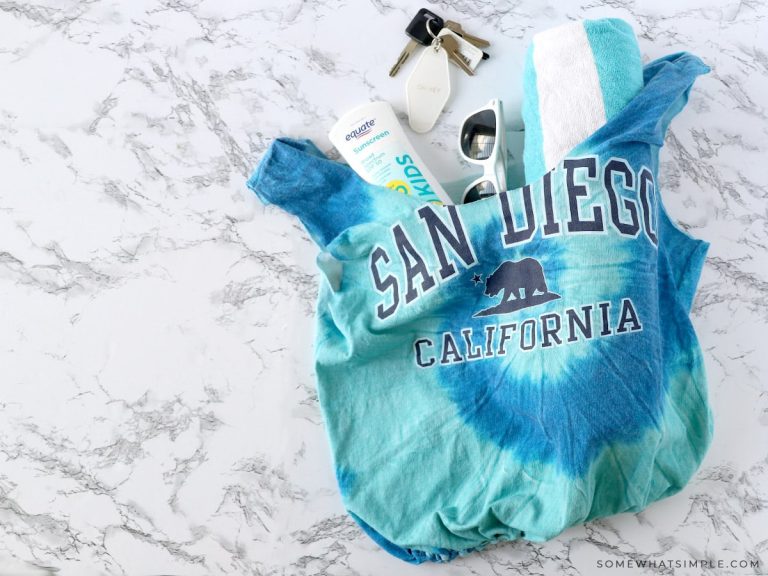 finished t shirt tote with sunscreen and a towel sticking out